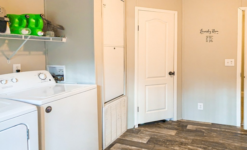 Laundry room with walk-in linen closet.