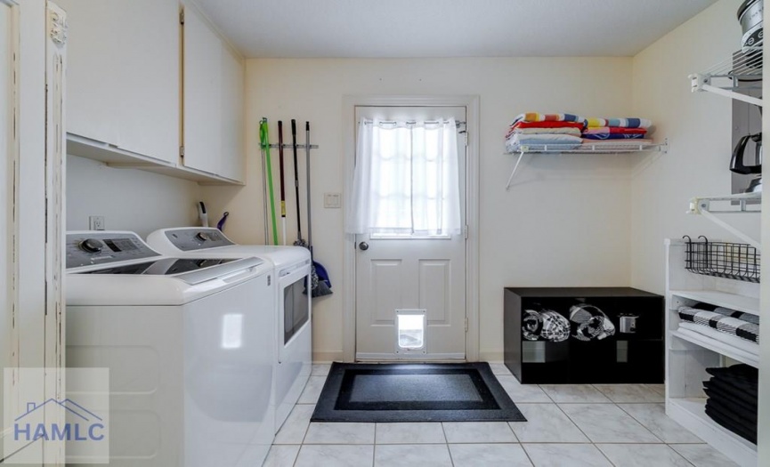 Laundry with storage; door to backyard